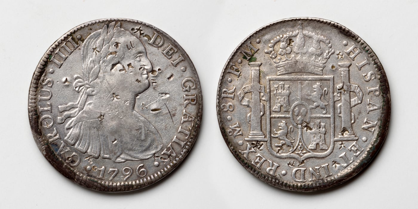 Obverse and reverse of a 1796 Spanish colonial eight-reales silver coin, showing the portrait of Carlos IIII and the crowned Spanish coat of arms.